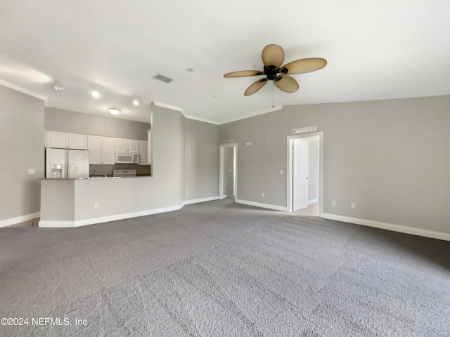 unfurnished living room with crown molding, ceiling fan, vaulted ceiling, and dark colored carpet