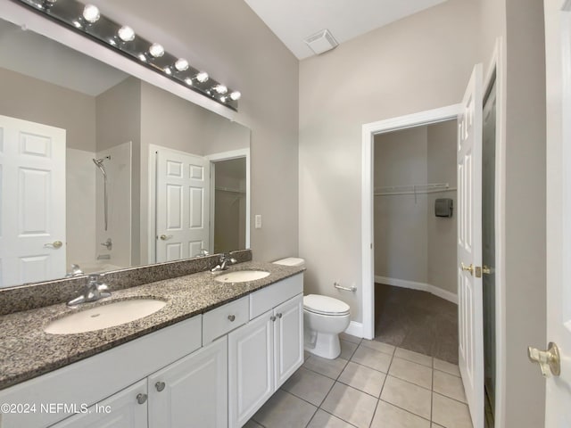 full bathroom with vanity, tile patterned floors, washtub / shower combination, and toilet