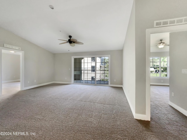 unfurnished living room with high vaulted ceiling, ceiling fan, and dark colored carpet