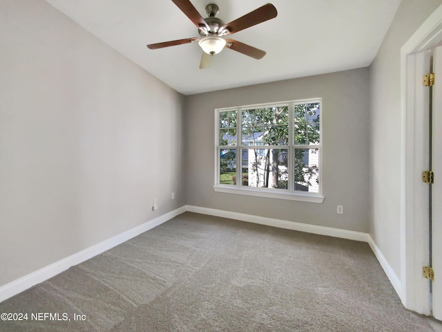 spare room featuring ceiling fan and carpet floors