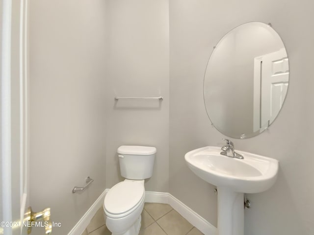 bathroom featuring tile patterned flooring and toilet