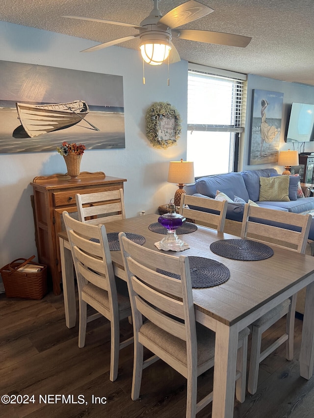 dining space with ceiling fan, dark hardwood / wood-style flooring, and a textured ceiling