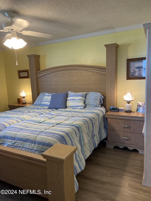 bedroom featuring ceiling fan, a textured ceiling, ornamental molding, and hardwood / wood-style floors