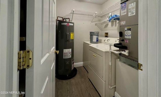 laundry area featuring water heater, dark hardwood / wood-style flooring, and separate washer and dryer