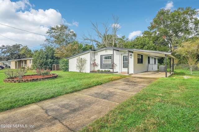 view of front of house with a carport and a front lawn