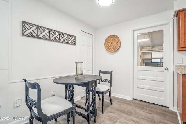 dining space with light hardwood / wood-style floors