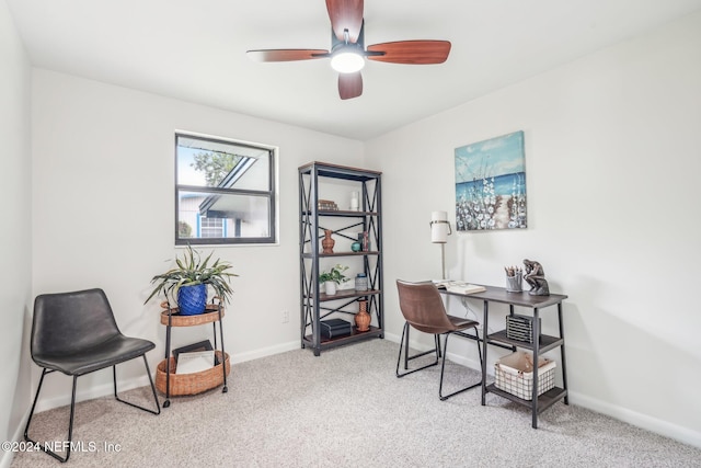 carpeted office space featuring ceiling fan