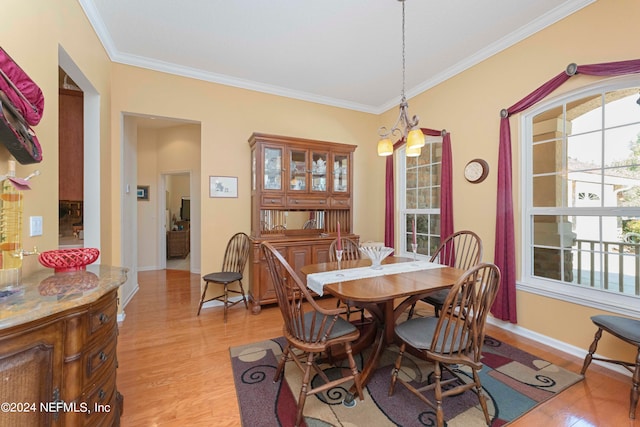 dining area featuring light hardwood / wood-style floors and ornamental molding