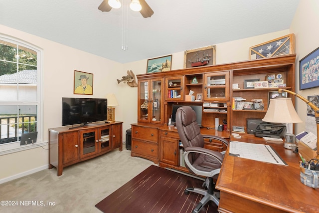 home office with ceiling fan, light carpet, and lofted ceiling