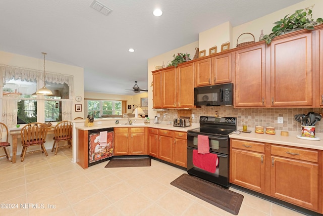 kitchen featuring hanging light fixtures, ceiling fan, light tile patterned floors, kitchen peninsula, and black appliances