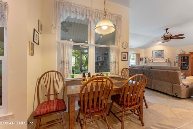 dining room with ceiling fan, lofted ceiling, and light tile patterned floors