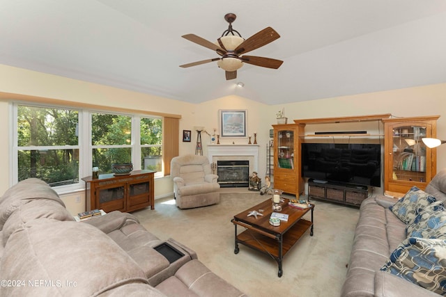 living room with ceiling fan, light carpet, and lofted ceiling