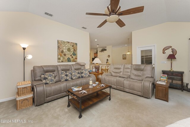 living room with light colored carpet, vaulted ceiling, and ceiling fan