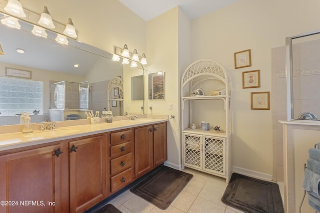 full bathroom with tile patterned flooring, double vanity, a sink, and walk in shower