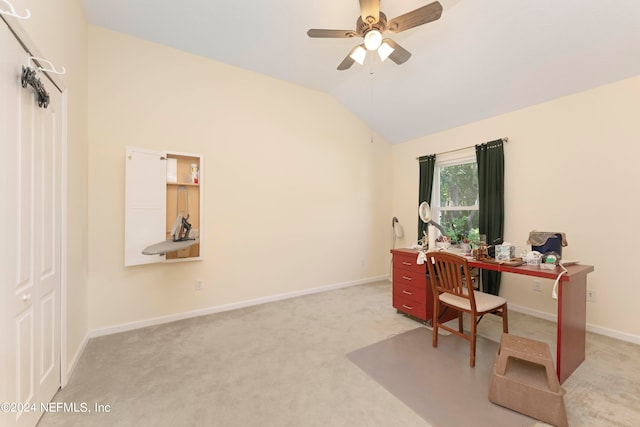 office featuring ceiling fan, lofted ceiling, and light colored carpet