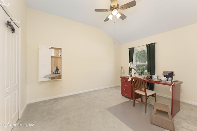 home office with lofted ceiling, baseboards, a ceiling fan, and light colored carpet