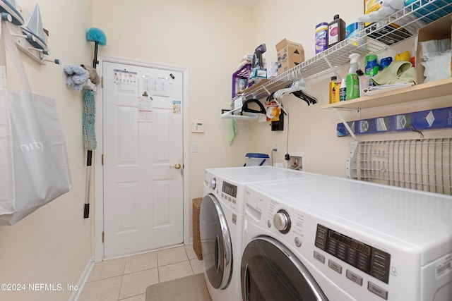 washroom featuring light tile patterned flooring and washing machine and dryer