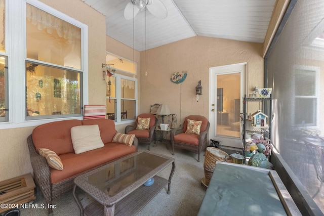 sunroom featuring lofted ceiling and a ceiling fan