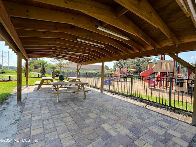 view of patio / terrace with a playground and fence