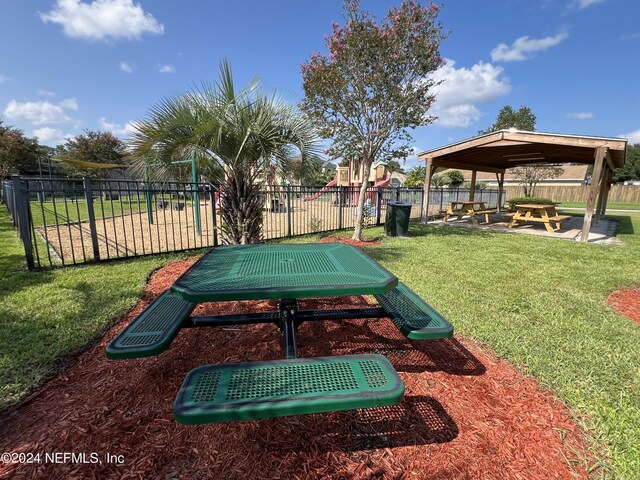 view of home's community with a gazebo, a playground, and a lawn