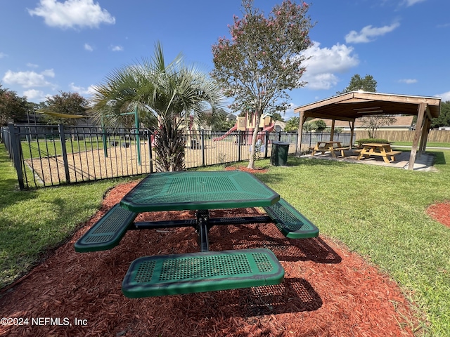 surrounding community with a yard, fence, and a gazebo