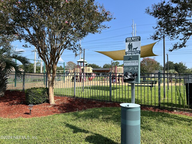 view of community with a playground and a lawn