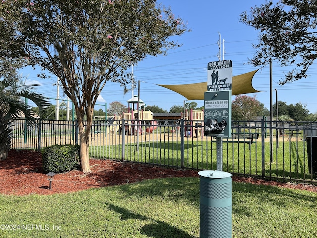 exterior space with fence and a lawn