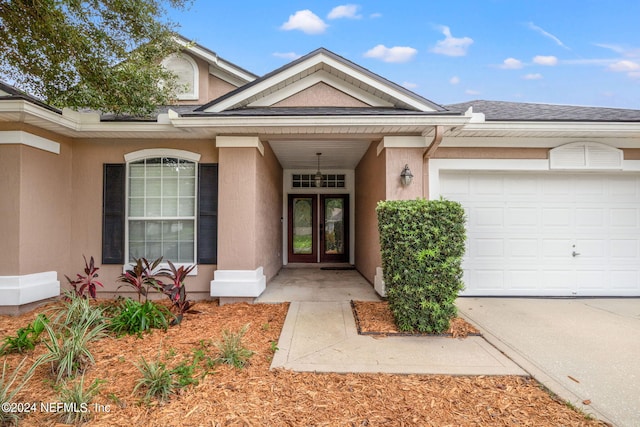 view of exterior entry with a garage