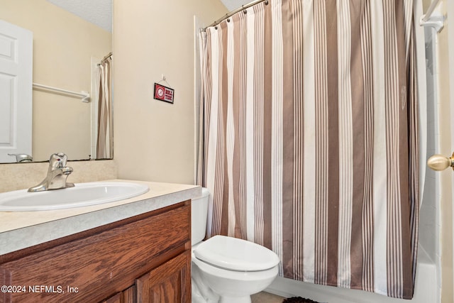 bathroom with vanity, a textured ceiling, and toilet