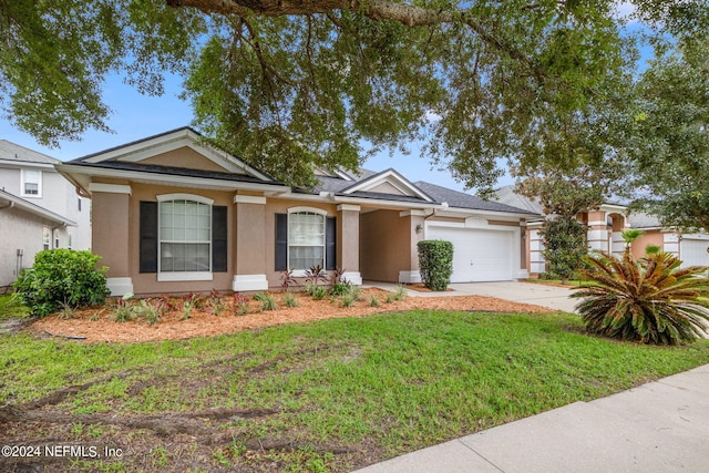 view of front of property with a front lawn and a garage