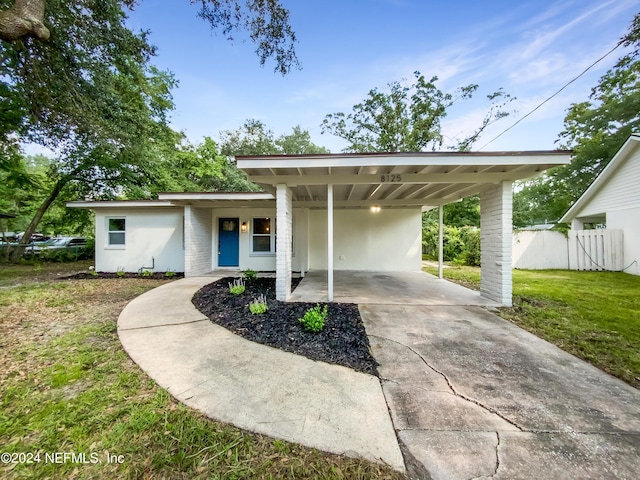 exterior space with a front lawn and a carport