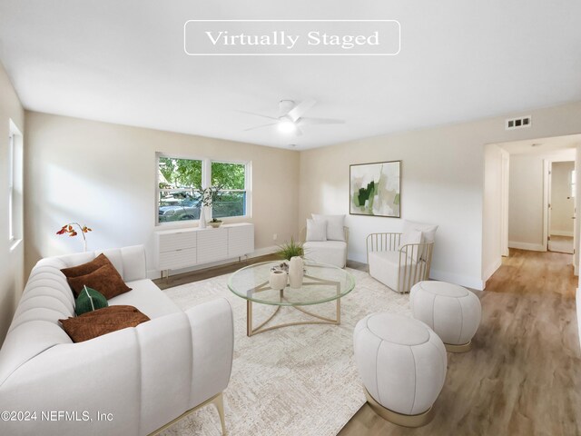 living room with ceiling fan and light hardwood / wood-style flooring