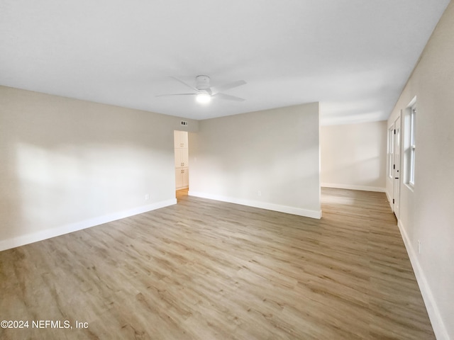 empty room with light wood-type flooring and ceiling fan