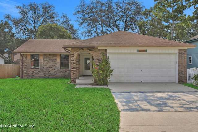 ranch-style house featuring a front lawn and a garage