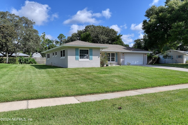 ranch-style house with a garage, driveway, a front lawn, and fence