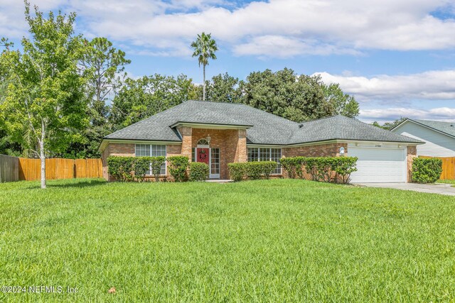 ranch-style home featuring a front lawn and a garage