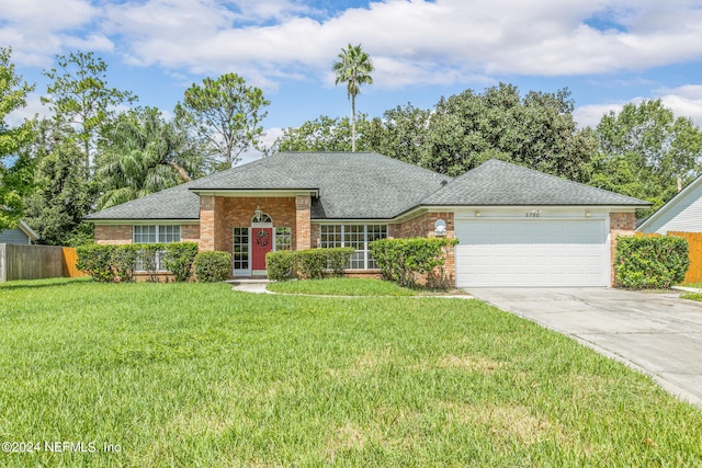 single story home featuring a front lawn and a garage