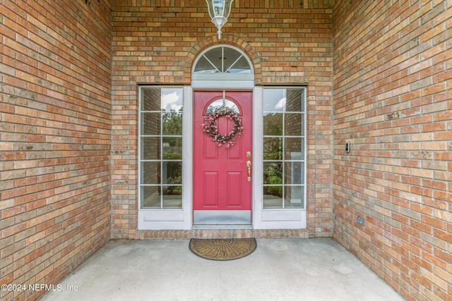 doorway to property featuring brick siding