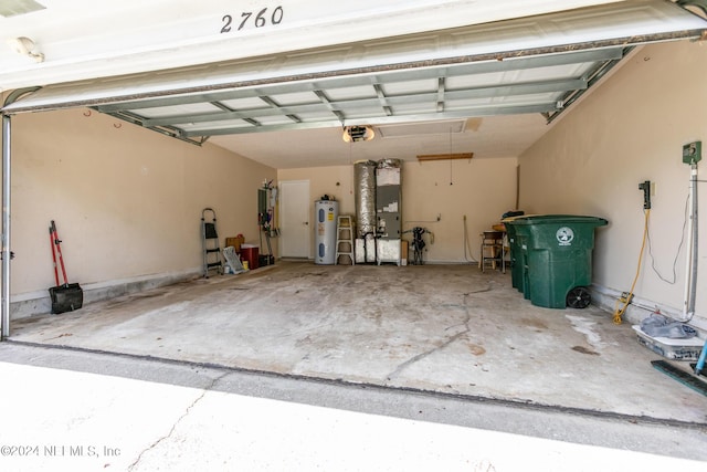 garage featuring water heater, heating unit, and a garage door opener