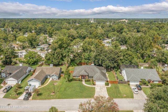 drone / aerial view with a residential view and a forest view