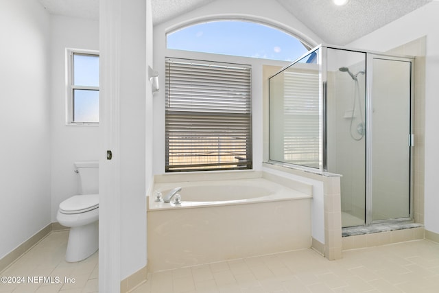 bathroom featuring toilet, a garden tub, vaulted ceiling, a textured ceiling, and a shower stall