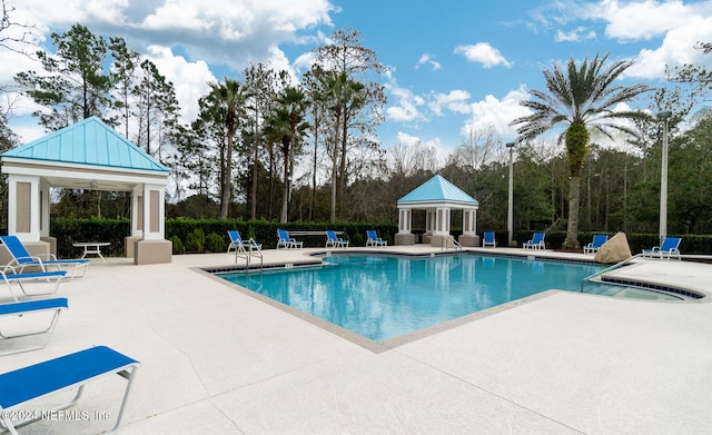 view of pool with a patio and a gazebo