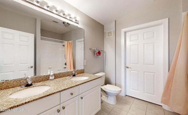 full bathroom featuring shower / bath combo, double sink vanity, toilet, and tile patterned flooring