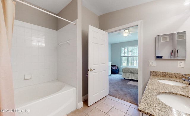 bathroom with double vanity, tiled shower / bath combo, ceiling fan, and tile patterned floors