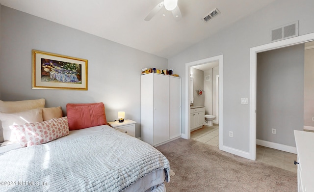 tiled bedroom with ceiling fan, ensuite bath, and vaulted ceiling