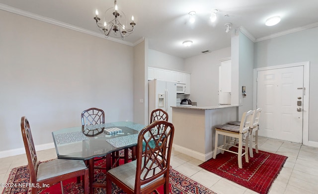 tiled dining area featuring a notable chandelier and ornamental molding