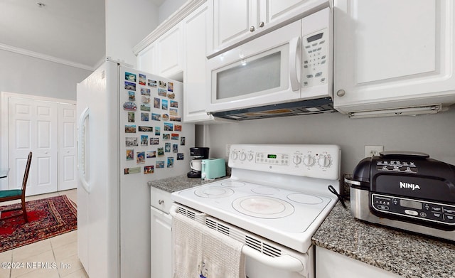 kitchen featuring stone counters, white cabinetry, crown molding, light tile patterned floors, and white appliances