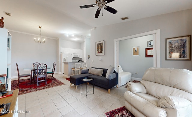 tiled living room featuring ceiling fan with notable chandelier and ornamental molding