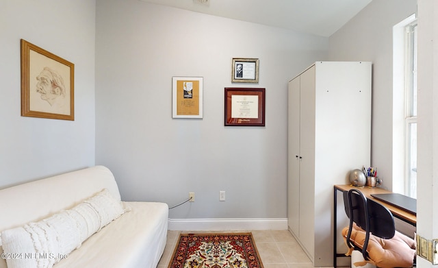 sitting room featuring light tile patterned flooring, a wealth of natural light, and lofted ceiling