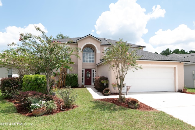 view of front of home with a garage and a front lawn